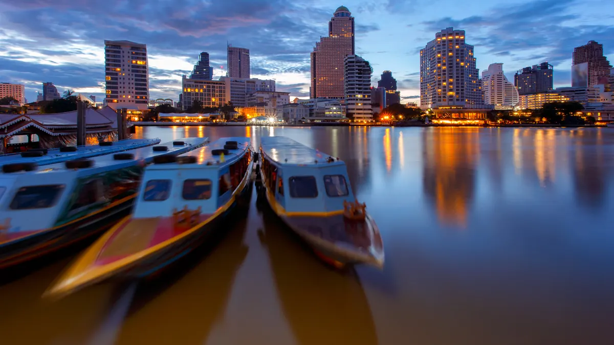 A river taxi at a pier on a wide city river
