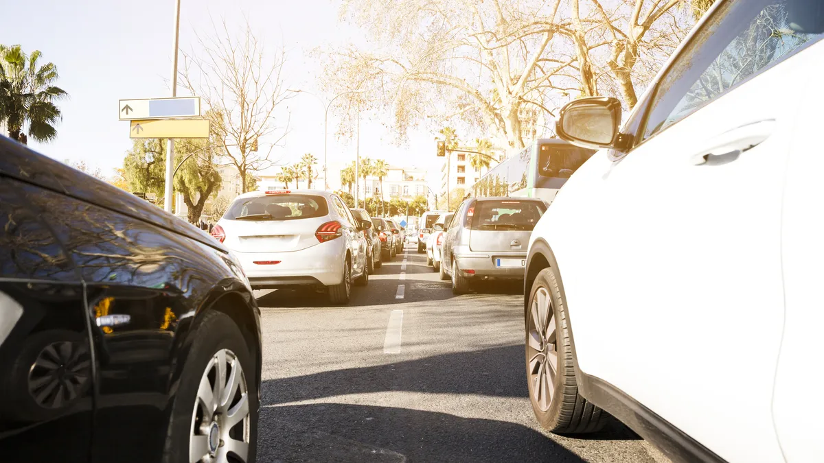 Cars queuing in holiday traffic on a sunny street