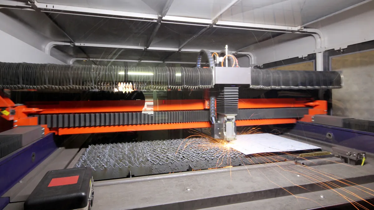 A CNC cutting machine cutting a sheet of metal