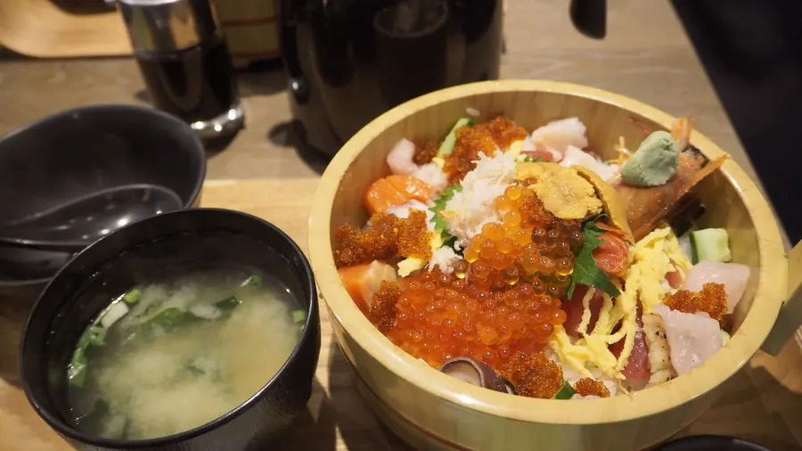 A seafood rice bowl with salmon roe and miso soup: Hokuriku seafood remains a reason to go, wherever the group eats it.
