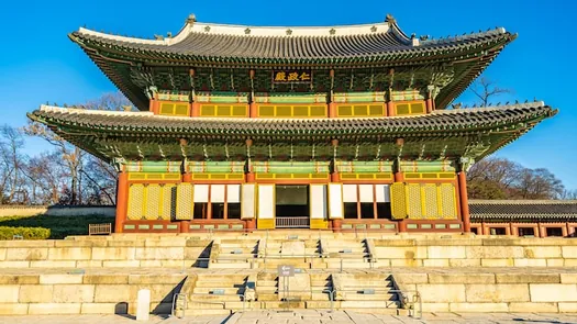 Injeongjeon, the throne hall of Changdeokgung Palace in Seoul, under a clear sky.