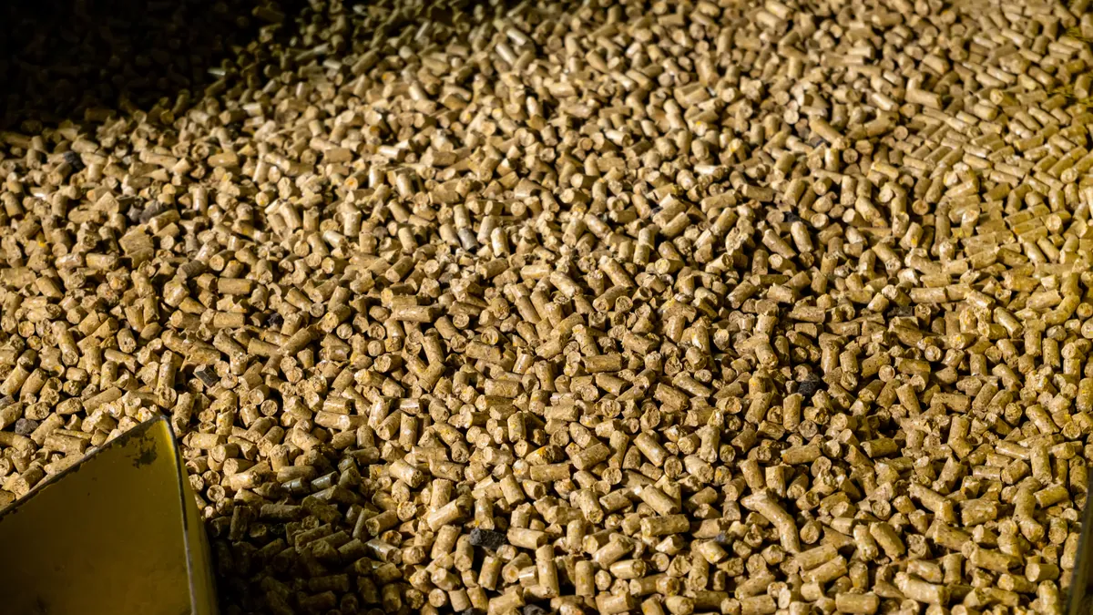 Animal feed pellets in bulk at a production plant.