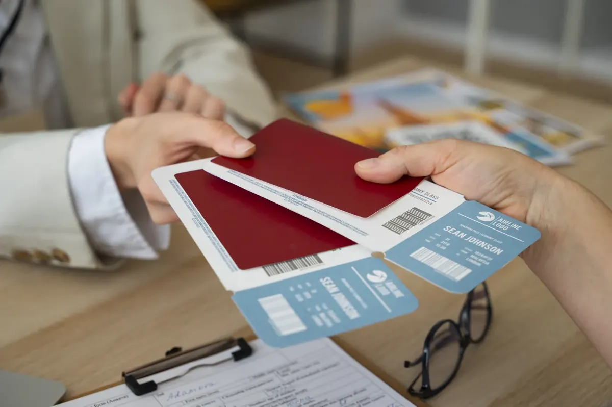Passports and boarding passes handed across a travel agent's desk
